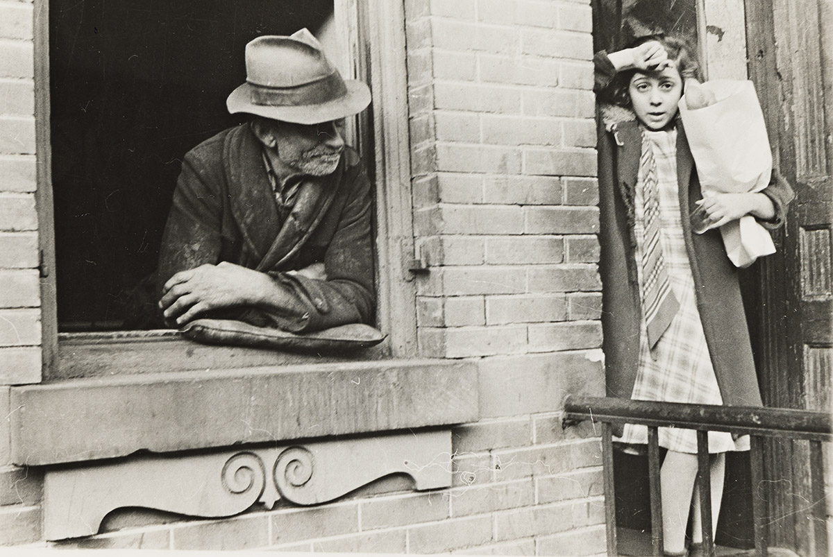 HELEN LEVITT (1913-2009) Girl holding bread and a man in the window, NYC.